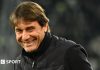 Head and shoulders view of a smiling Antonio Conte in a black, zipped-up jacket