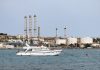 yacht-on-water-near-industrial-refinery-coastal-facility.jpg - RevistaPolitica